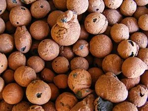 Primer plano de gránulos de arcilla expandida de distintos tamaños, con superficies porosas y formas redondeadas e irregulares. Primer plano de gránulos de arcilla expandida de distintos tamaños, con superficies porosas y formas redondeadas e irregulares.
