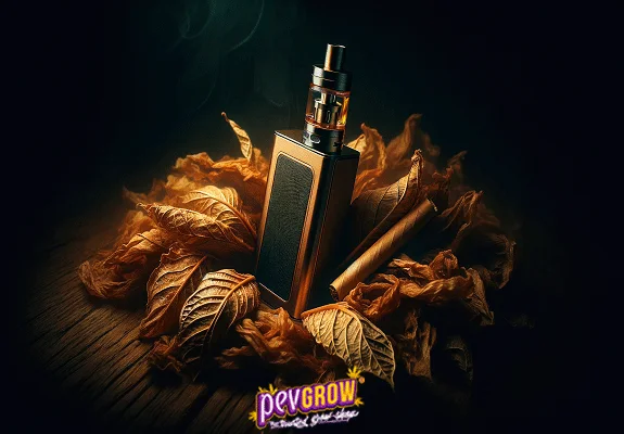 Vapeador rectangular de pie entre hojas secas marrones y un rollo de tabaco sobre una superficie de madera con fondo oscuro.