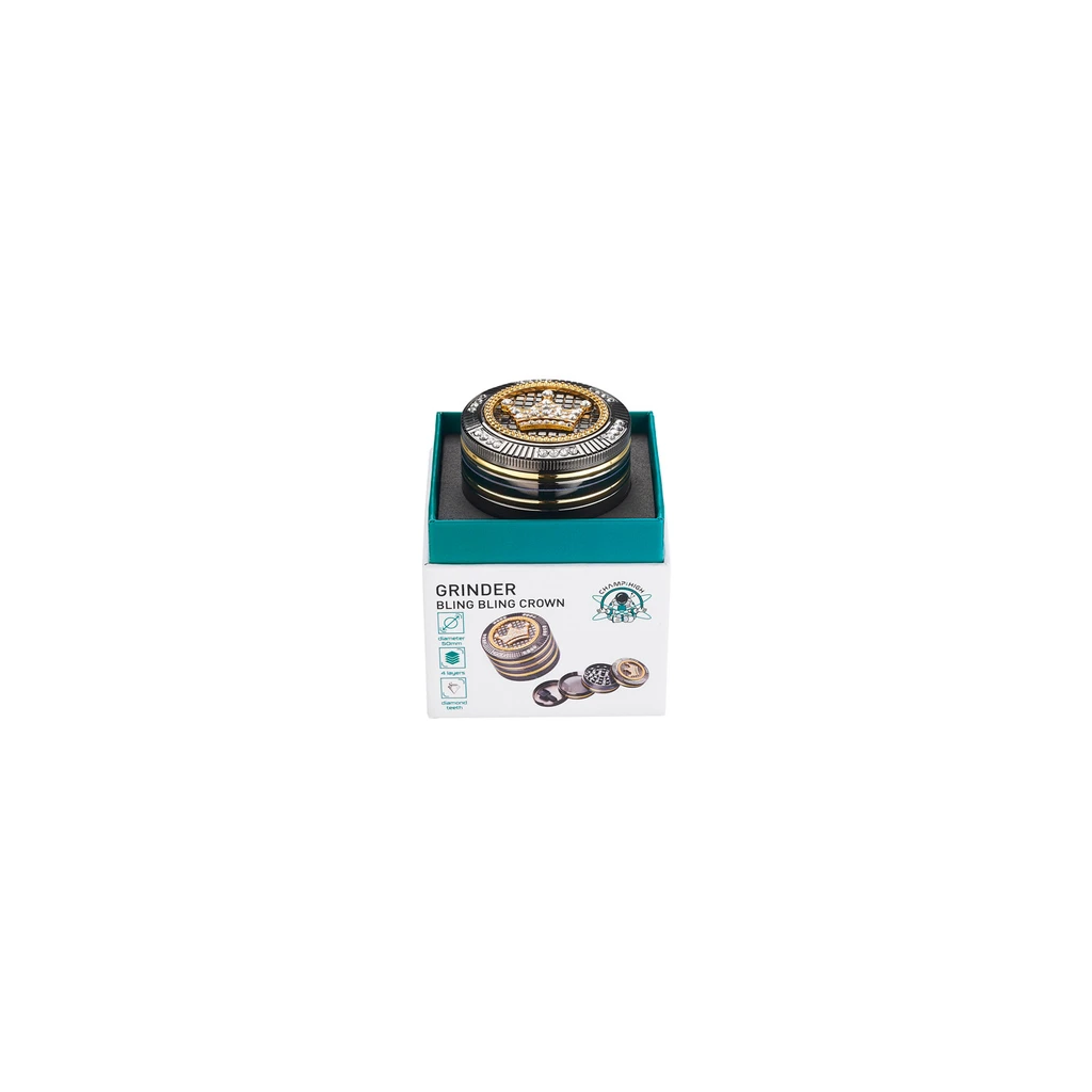 Grinder Champ Bling Bling Crown en caja abierta, con acabado negro y dorado y una corona con brillantes en la tapa.