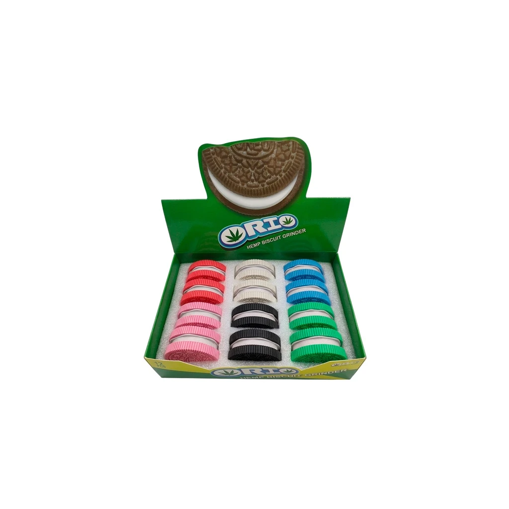 Expositor verde Orio abierto con varios grinders en forma de galleta rellena, en distintos colores y dispuestos en filas. Expositor verde Orio abierto con varios grinders en forma de galleta rellena, en distintos colores y dispuestos en filas.