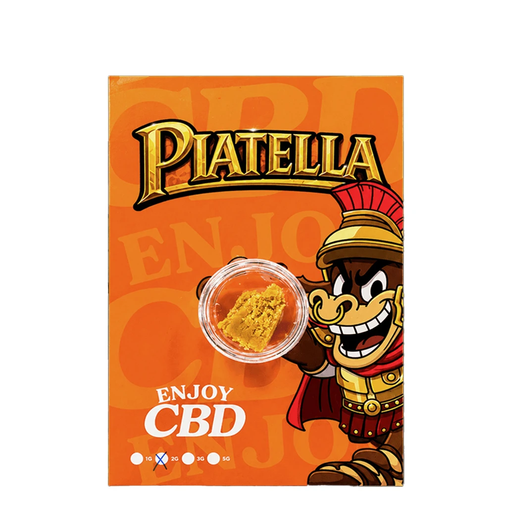 Hash Enjoy Piatella en un recipiente transparente sobre un envase naranja con un personaje de casco romano y el texto «Enjoy CBD».