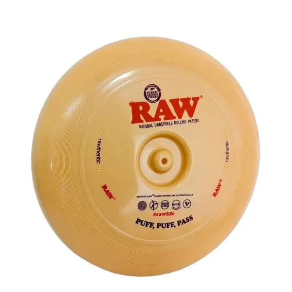 Disco circular RAW Flying Disk Tray de tono dorado, con relieve central, logotipo rojo y texto «Puff, puff, pass».