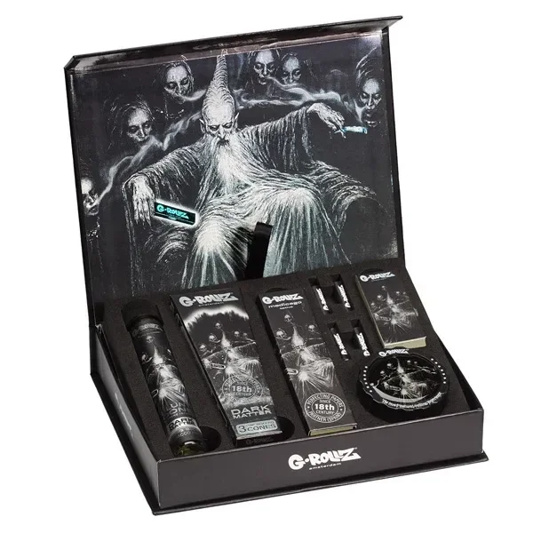 Caja G-Rollz Dark Matter abierta, con accesorios en compartimentos y una ilustración de un personaje barbudo rodeado de figuras oscuras.