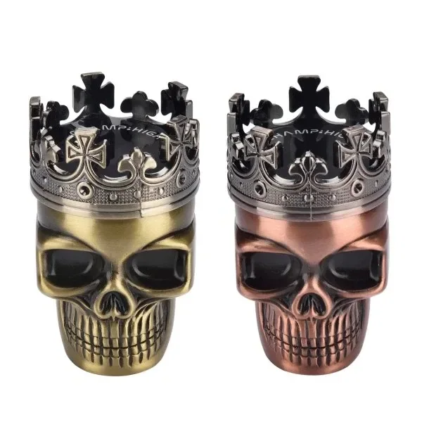 Grinders King Skull CHAMP con forma de calavera coronada, en acabados dorado y cobrizo, con coronas plateadas decoradas con cruces.