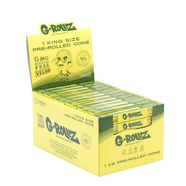 Expositor amarillo y verde G-Rollz King Size Bamboo con cajas alargadas de conos preenrollados y una ilustración de un rostro con gorro.