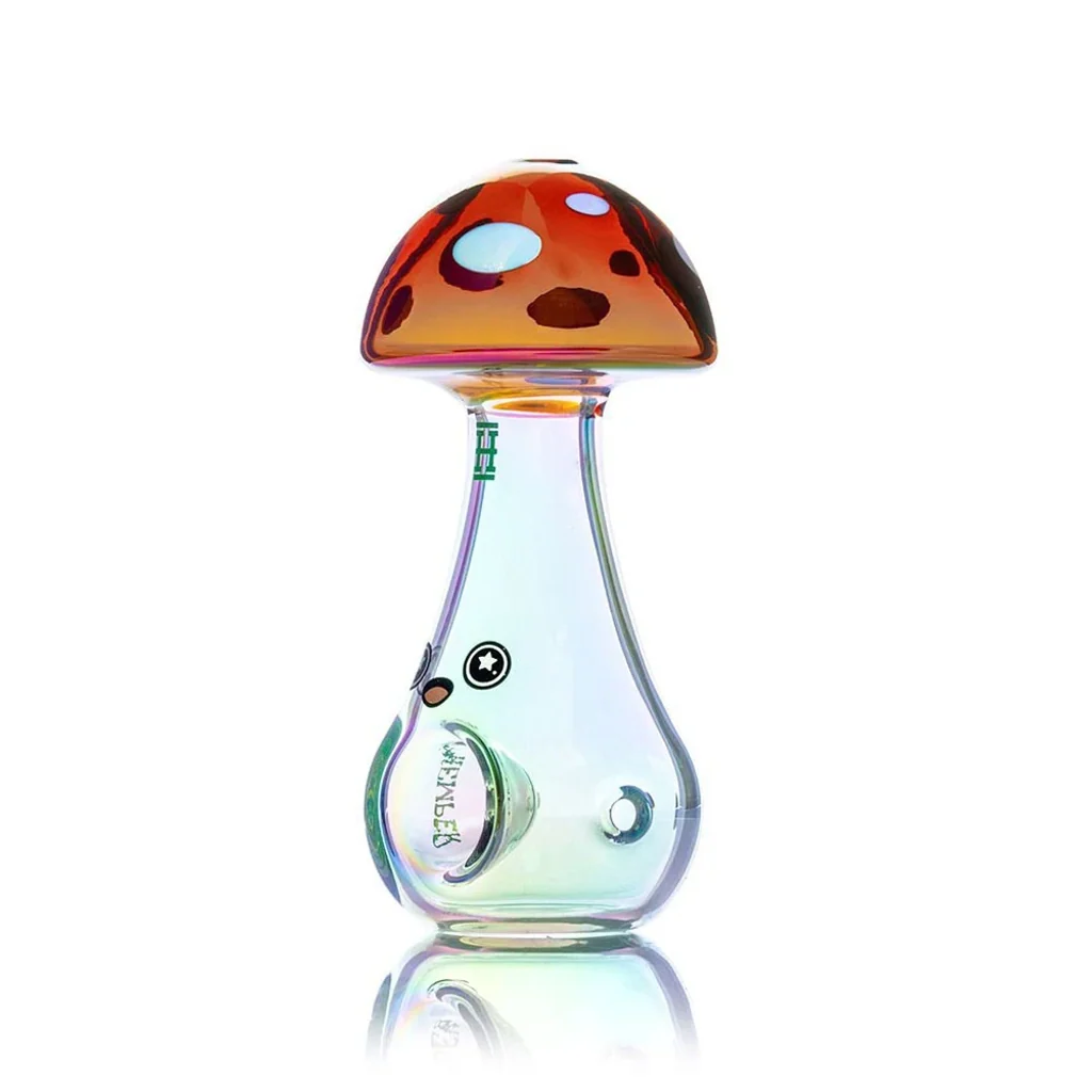 Pipa de cristal Hemper Trippy Shroom con forma de seta, sombrero naranja con manchas y cuerpo transparente de reflejos irisados.