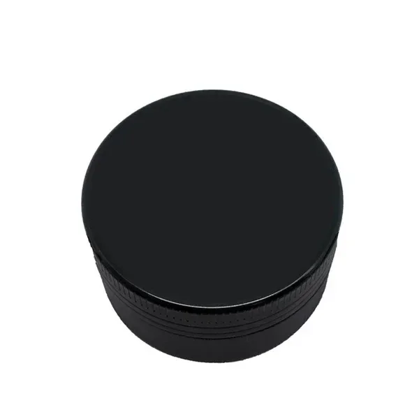Grinder negro cerrado, de forma cilíndrica, con tapa lisa y bordes estriados, visto en perspectiva sobre fondo blanco.