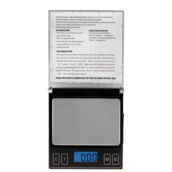 Báscula digital USA Weight Kansas CD 100 abierta, con plataforma plateada, pantalla azul que marca 0.00 e instrucciones en la tapa.
