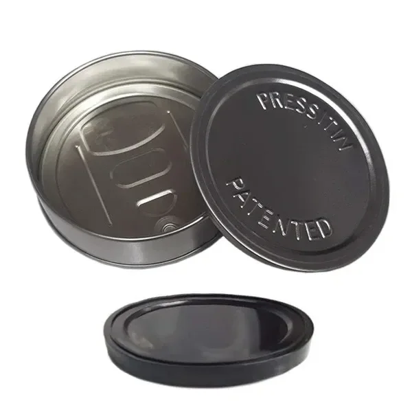 Lata metálica abierta con fondo de abrefácil, tapa con las palabras «PRESSITIN PATENTED» y pieza circular negra separada.