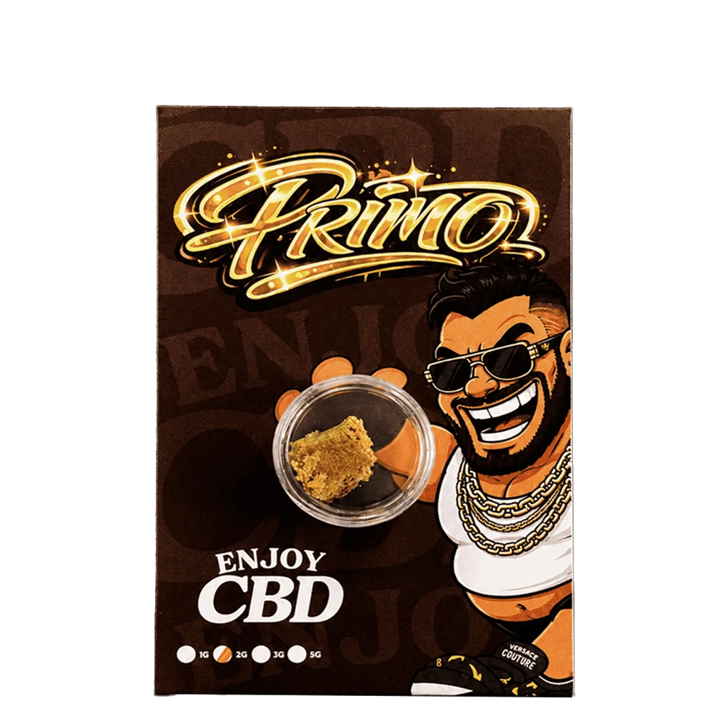 Envase marrón de Enjoy Primo CBD con recipiente transparente de contenido dorado y personaje ilustrado con gafas de sol y cadenas.