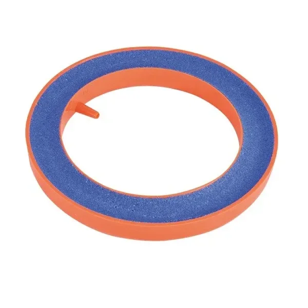 Piedra oxigenadora circular con superficie azul, borde naranja y una pequeña conexión orientada hacia el interior del anillo.