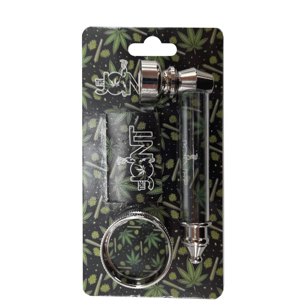 Blíster de The Joint con pipa de piezas plateadas y cuerpo oscuro, accesorio rectangular y grinder circular con dibujos de hojas verdes.