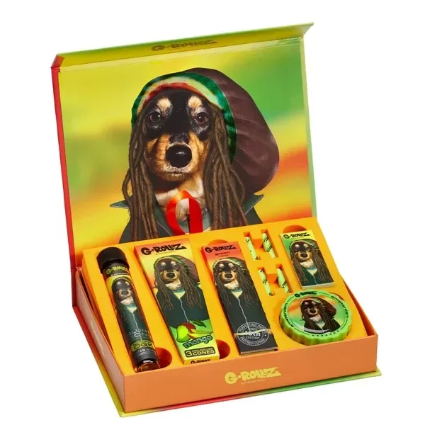 Caja regalo G-Rollz Reggae abierta, con accesorios en compartimentos y un perro con rastas y capucha ilustrado en la tapa.