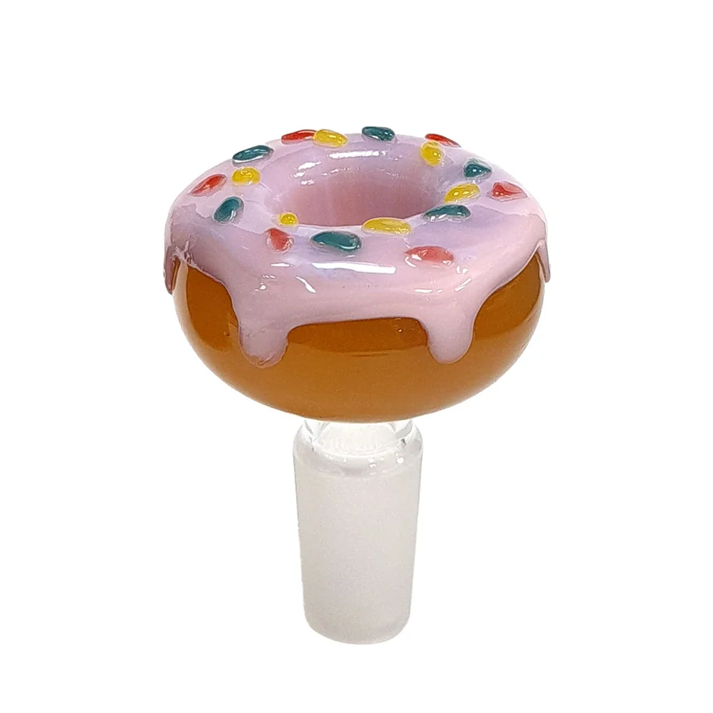 Cazoleta de cristal con forma de donut, cobertura rosa y adornos de colores, sobre una conexión translúcida y fondo blanco.