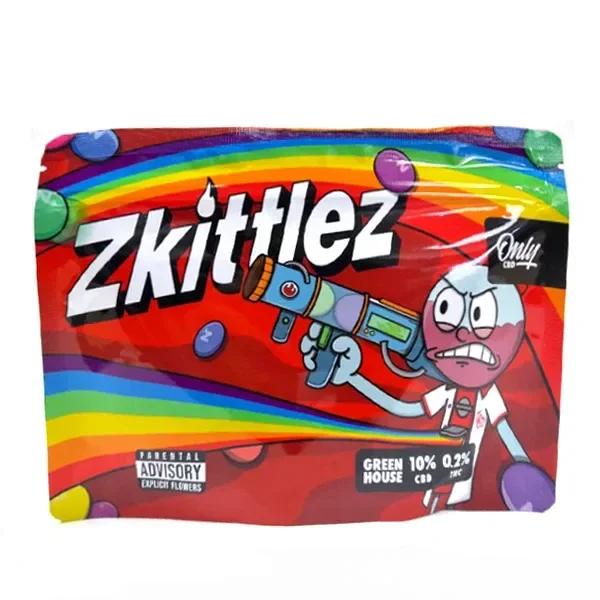 Bolsa de cáñamo Zkittlez OnlyCBD con fondo rojo, franjas de arcoíris y un personaje de dibujos que sostiene una pistola de colores.