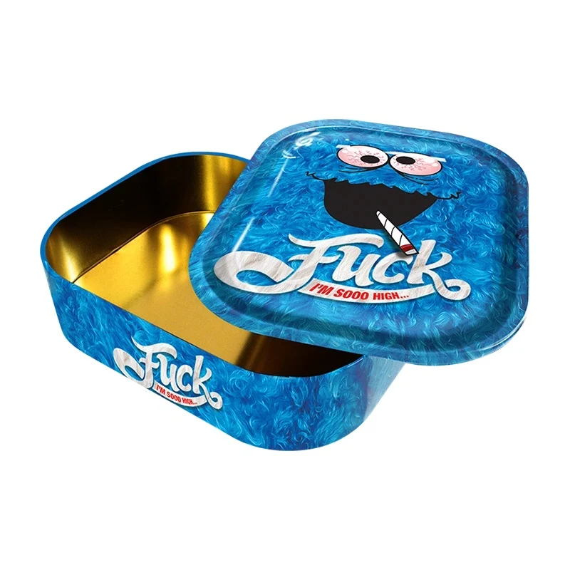 Caja Monster azul abierta, con interior dorado y tapa desplazada decorada con un personaje de ojos rosados y el texto «Fuck, I'm sooo high…».