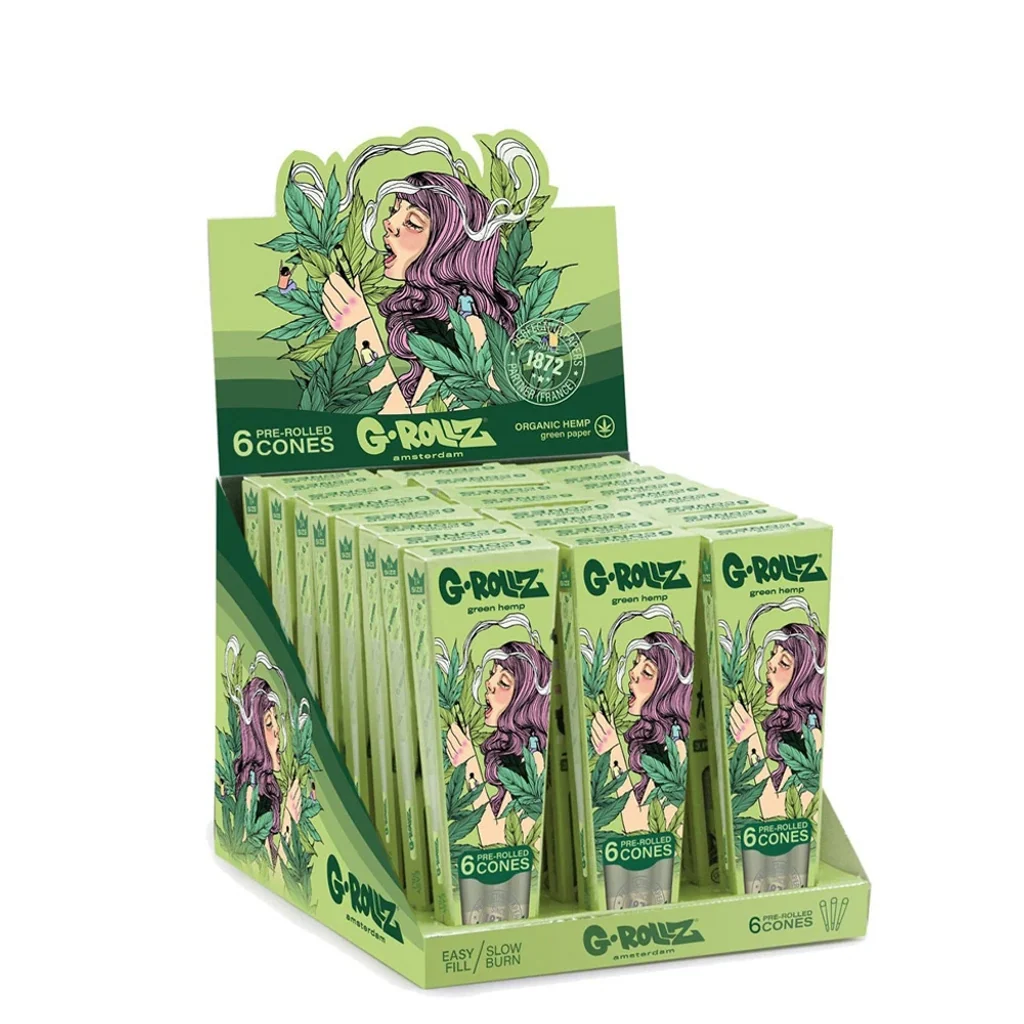 Expositor verde de conos G-Rollz con varios envases ilustrados con una mujer de pelo morado entre hojas y la inscripción «6 pre-rolled cones».
