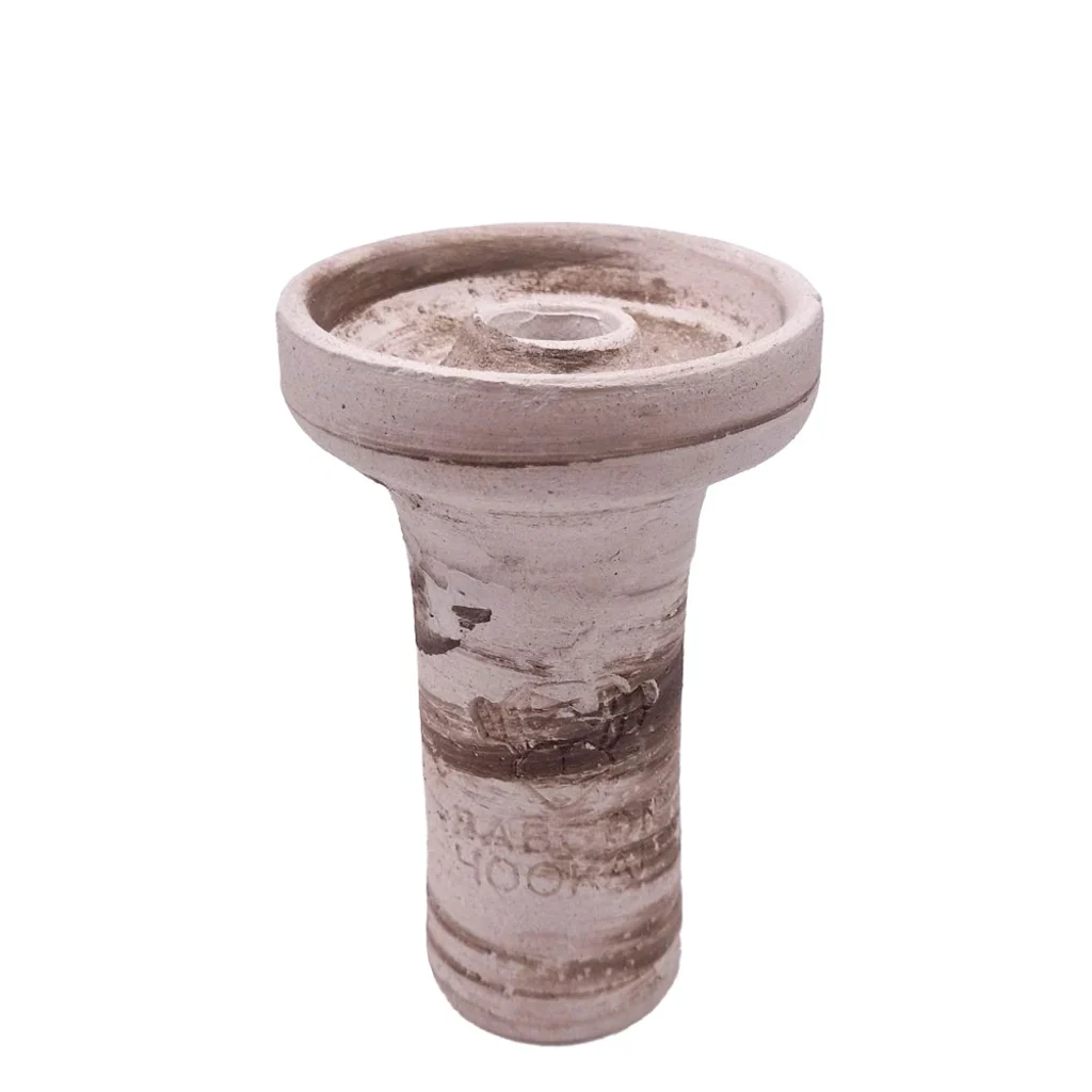Cazoleta de shisha de cerámica en tonos beige y marrón, con pie alto, recipiente ancho y orificio central elevado, sobre fondo blanco.