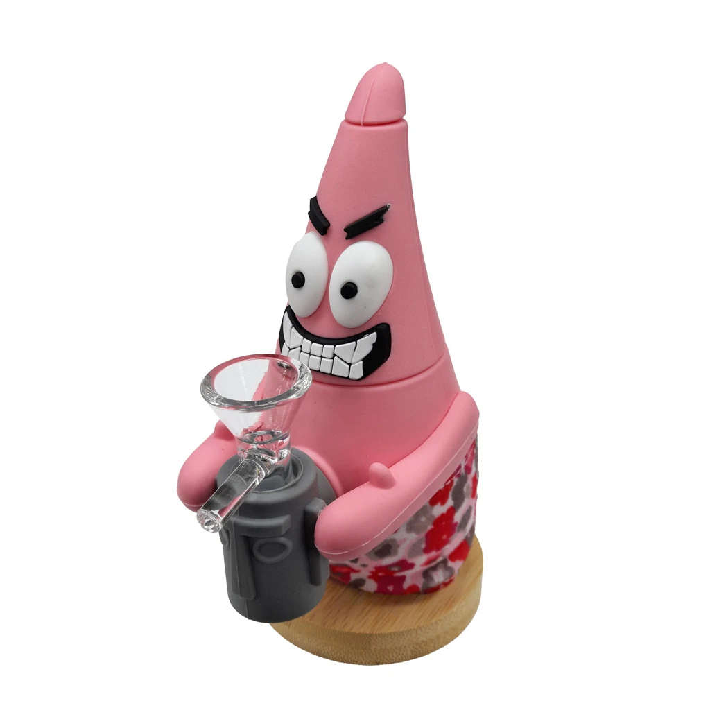 Bong con forma de Patricio rosa, ojos saltones y sonrisa dentada, con cazoleta transparente frontal y base redonda.