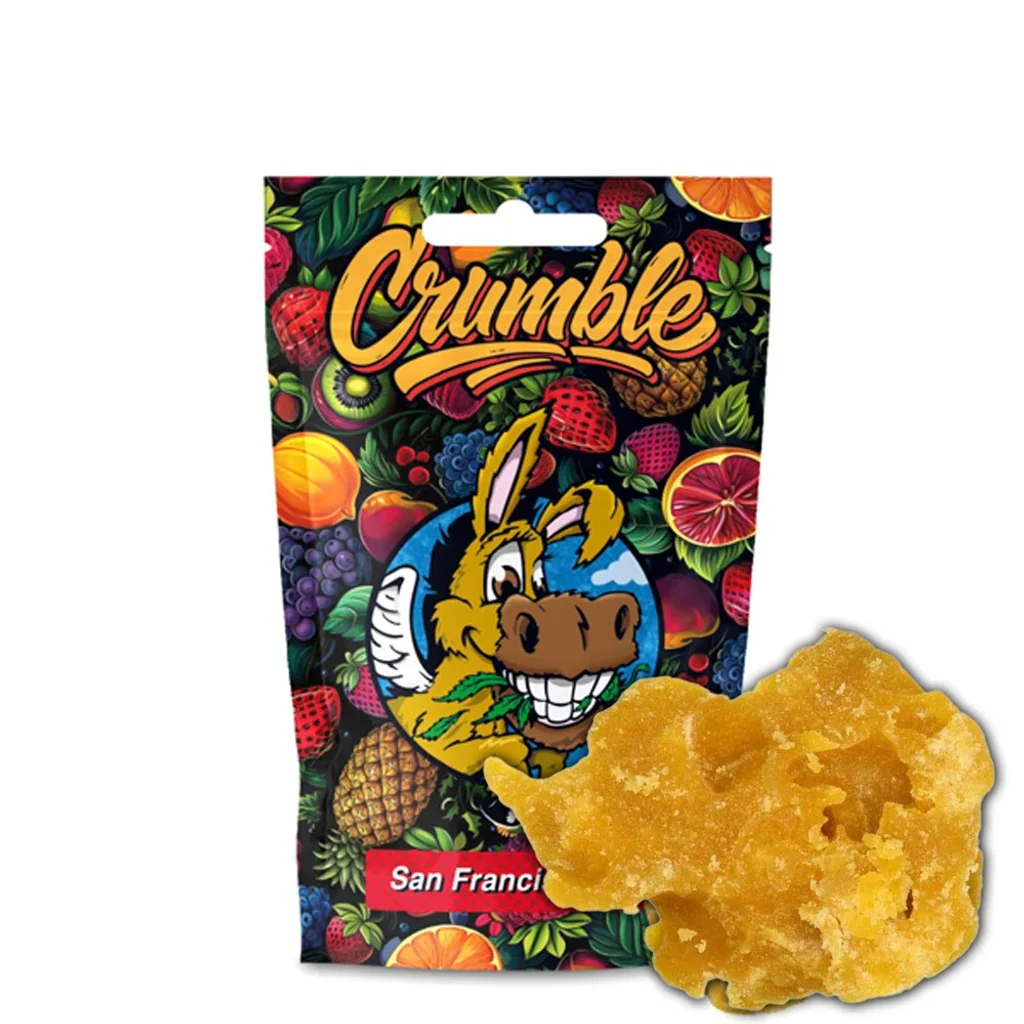 Crumble Flying Burrito San Francisco de color amarillo dorado delante de una bolsa decorada con frutas y un burro sonriente.