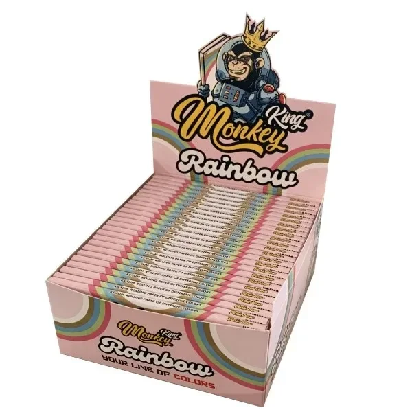 Expositor rosa de papel Monkey King Rainbow con varios libritos alineados, franjas de arcoíris y un mono coronado en la cabecera.