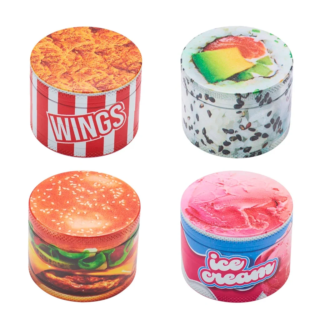 Selección de grinders cilíndricos Fantasy con diseños de alitas de pollo, sushi, hamburguesa y helado, sobre fondo blanco.