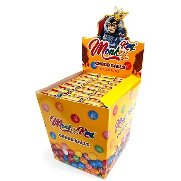 Expositor amarillo de papel Monkey King Choco Balls con varios libritos, motivos de bolas de colores y un mono coronado.