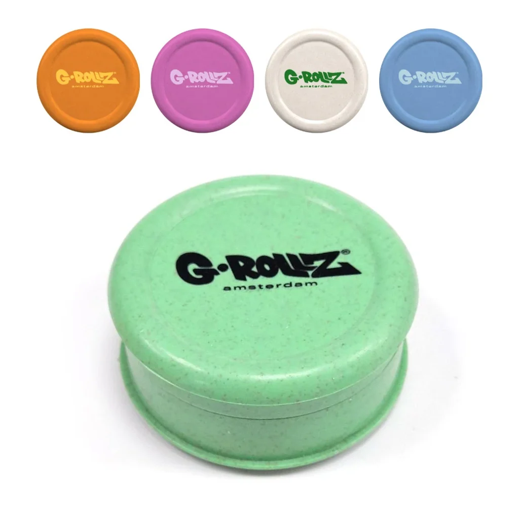 Grinder G-Rollz verde con tapa circular y logotipo negro, acompañado de vistas de las variantes naranja, rosa, blanca y azul.