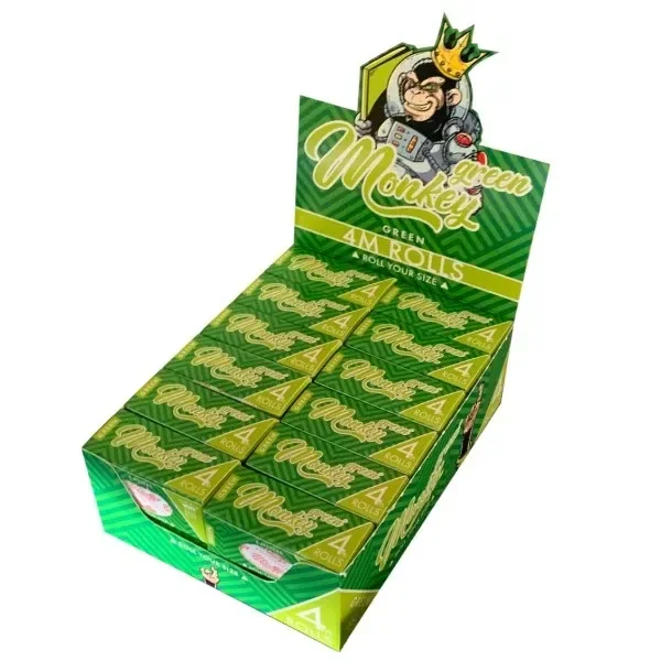 Expositor verde de papel Monkey King Rolls con varias cajas y un mono coronado en la cabecera; los envases indican «4M Rolls».
