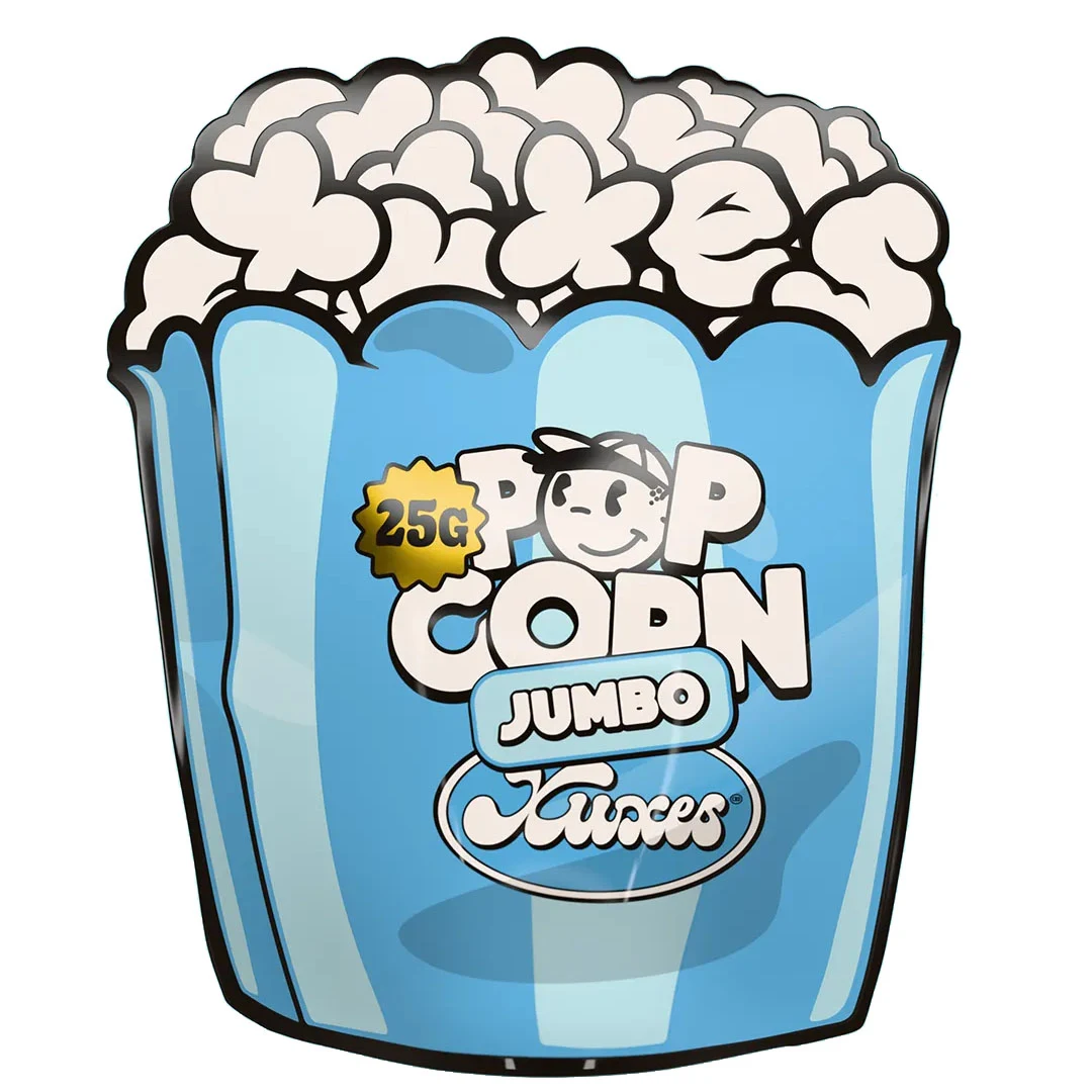 Envase azul Xuxes Pop Corn Jumbo con silueta de cubo de palomitas, letras blancas, personaje sonriente y distintivo de 25 g.
