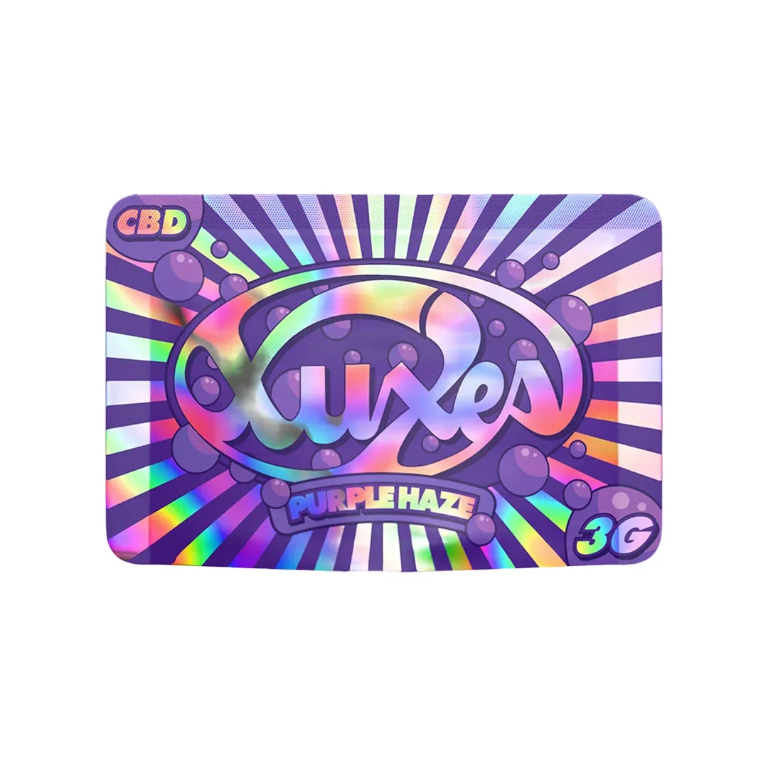 Envase de Xuxes Purple Haze con diseño morado y reflejos multicolor, motivos radiales y las inscripciones CBD y 3G.
