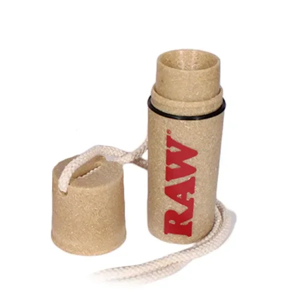 Recipiente cilíndrico RAW de tono marrón claro, abierto, con tapa separada unida por un cordón y logotipo rojo sobre fondo blanco.