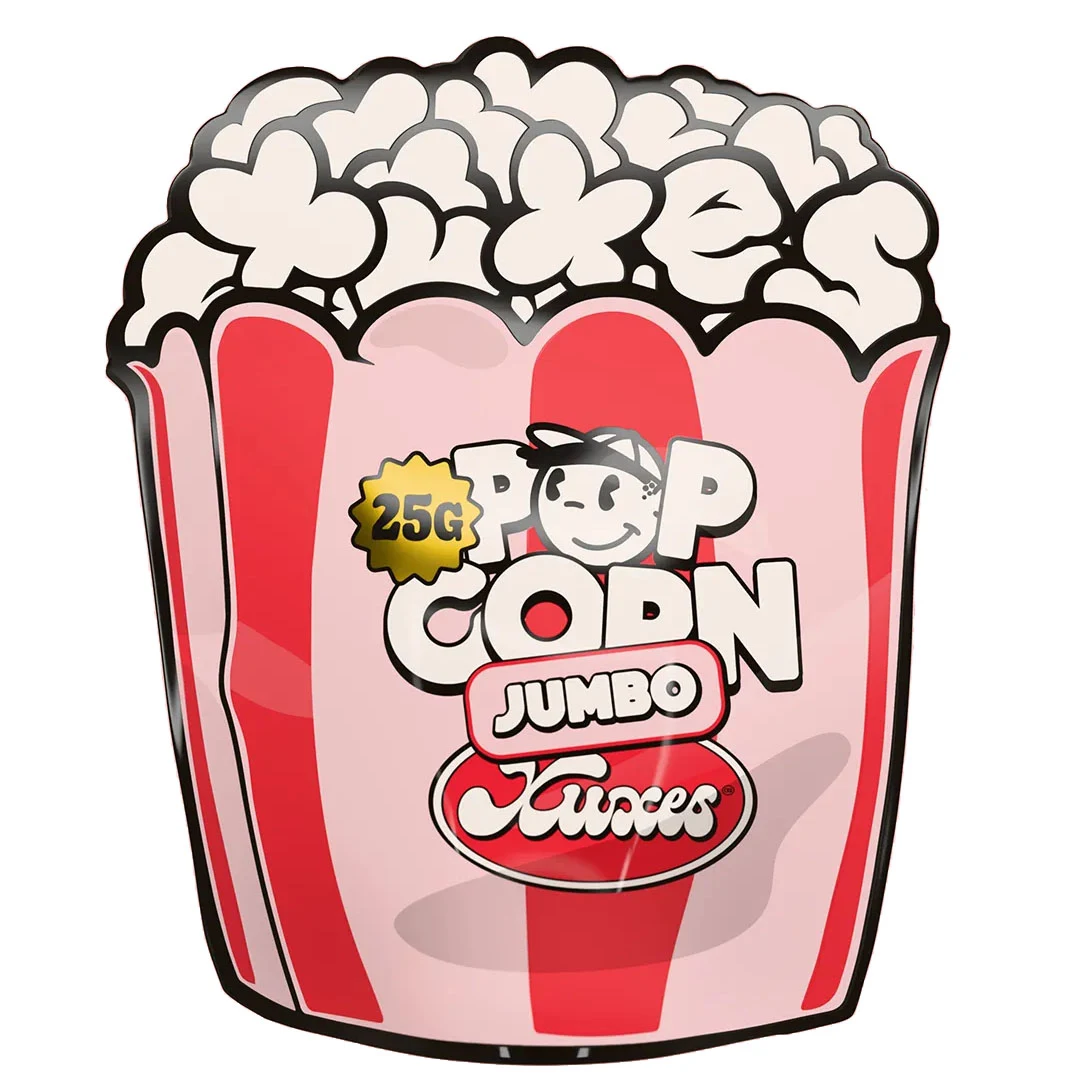 Envase Xuxes Pop Corn Jumbo con forma de cubo de palomitas, franjas rosas y rojas, personaje sonriente y distintivo de 25 g.