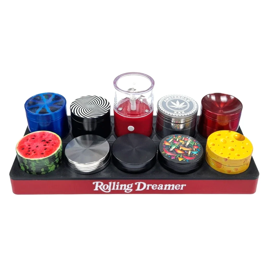 Expositor Rolling Dreamer con diez grinders de distintos formatos y colores, con diseños de sandía, espiral, setas y queso.