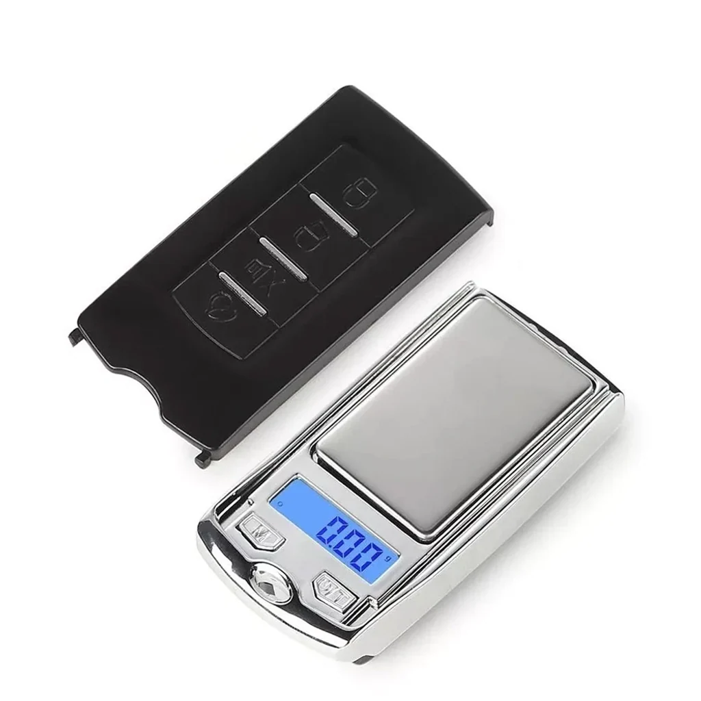 Báscula digital Easy Garden Vito 100 con plataforma plateada, pantalla azul que marca 0.00 g y tapa negra retirada a un lado.