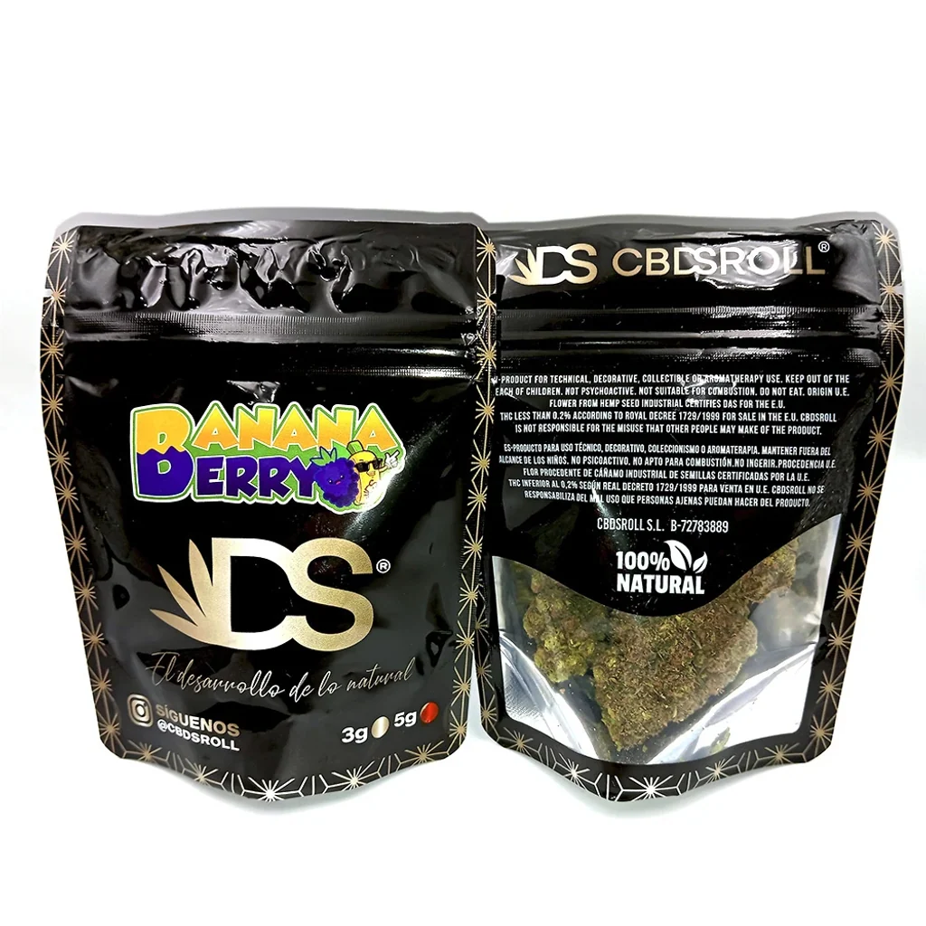 Envase negro de CBDSROLL Banana Berry mostrado por delante y por detrás, con letras de colores y ventana transparente que deja ver cogollos.