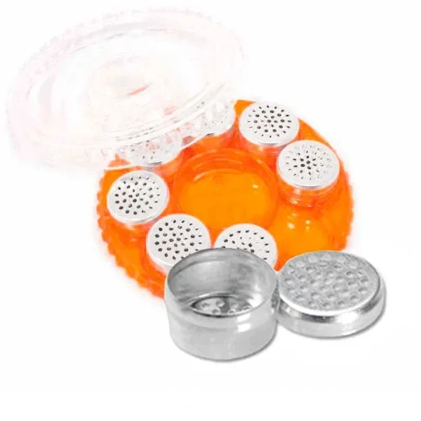 Estuche circular naranja STORZ & BICKEL abierto, con cápsulas plateadas de tapa perforada y una cápsula abierta en primer plano.