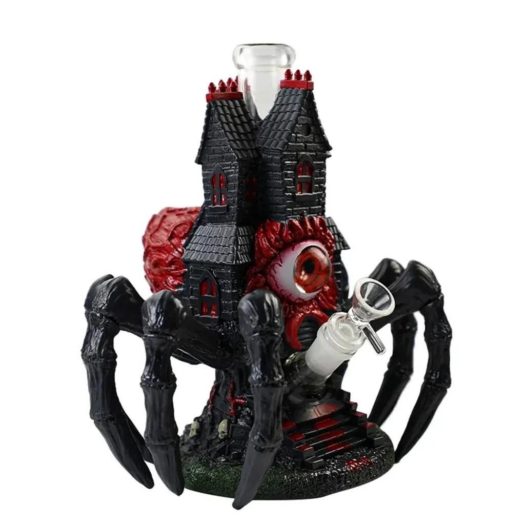 Bong Spider Castle con castillo negro, gran ojo rojo y patas de araña, con tubo transparente superior y cazoleta lateral transparente.