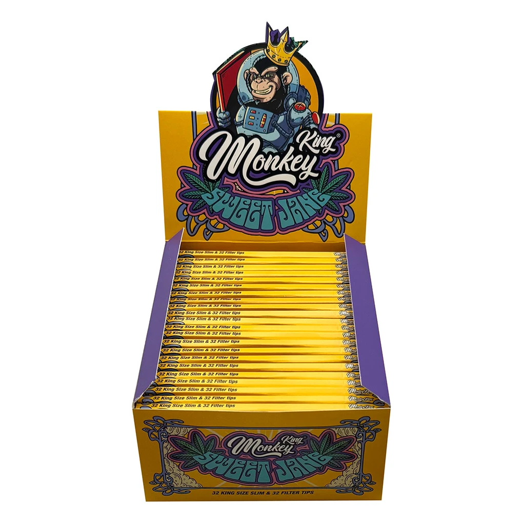 Expositor amarillo y morado con librillos Monkey King Sweet Jane alineados y un mono con corona y traje espacial en la cabecera.