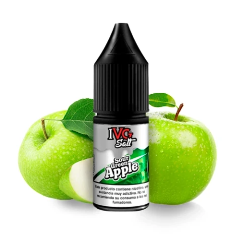 Frasco de IVG Salt Sour Green Apple con tapón negro y etiqueta blanca y verde, delante de manzanas verdes y una rodaja.