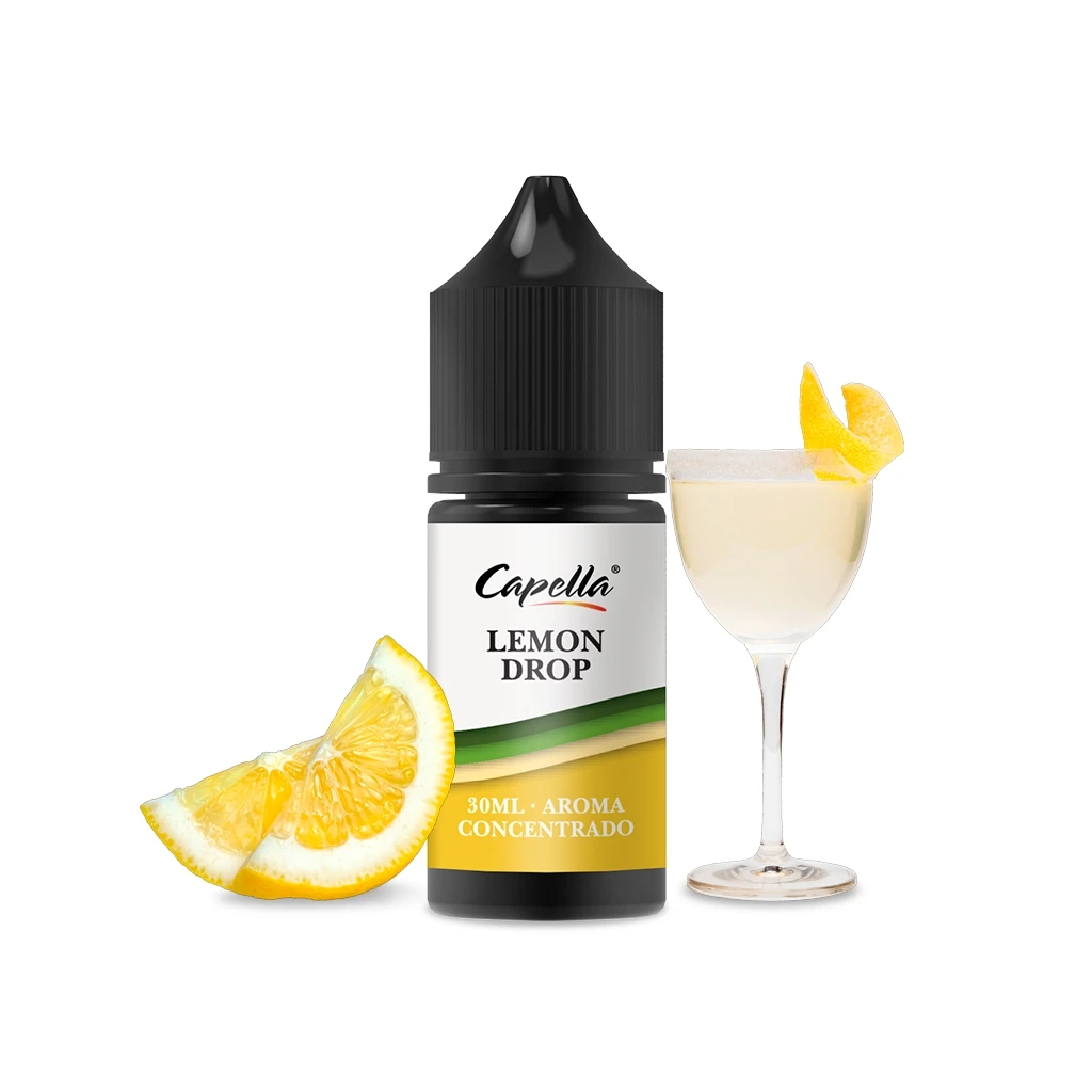 Frasco de aroma Capella Lemon Drop de 30 ml con tapón negro, junto a gajos de limón y una copa con bebida clara.