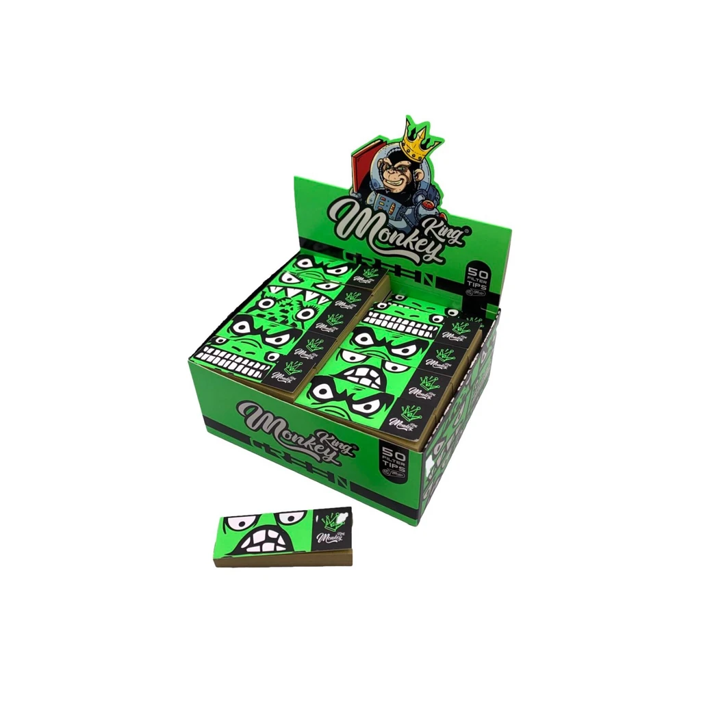 Expositor de filtros Regular Green de Monkey King, con librillos verdes decorados con caras y uno colocado delante. Expositor de filtros Regular Green de Monkey King, con librillos verdes decorados con caras y uno colocado delante.