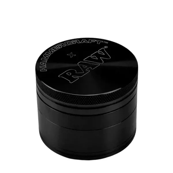 Grinder negro cilíndrico RAW, cerrado, con varias secciones, borde moleteado y logotipos RAW y Hammercraft grabados en la tapa.