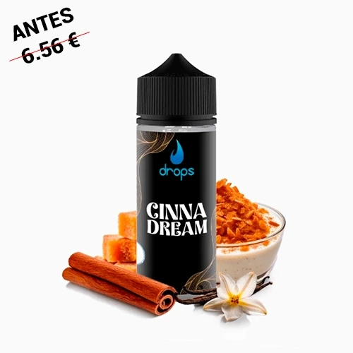 Botella Drops Cinnadream con tapón negro, rodeada de ramas de canela, pequeños dados, una flor y un cuenco con cobertura naranja.