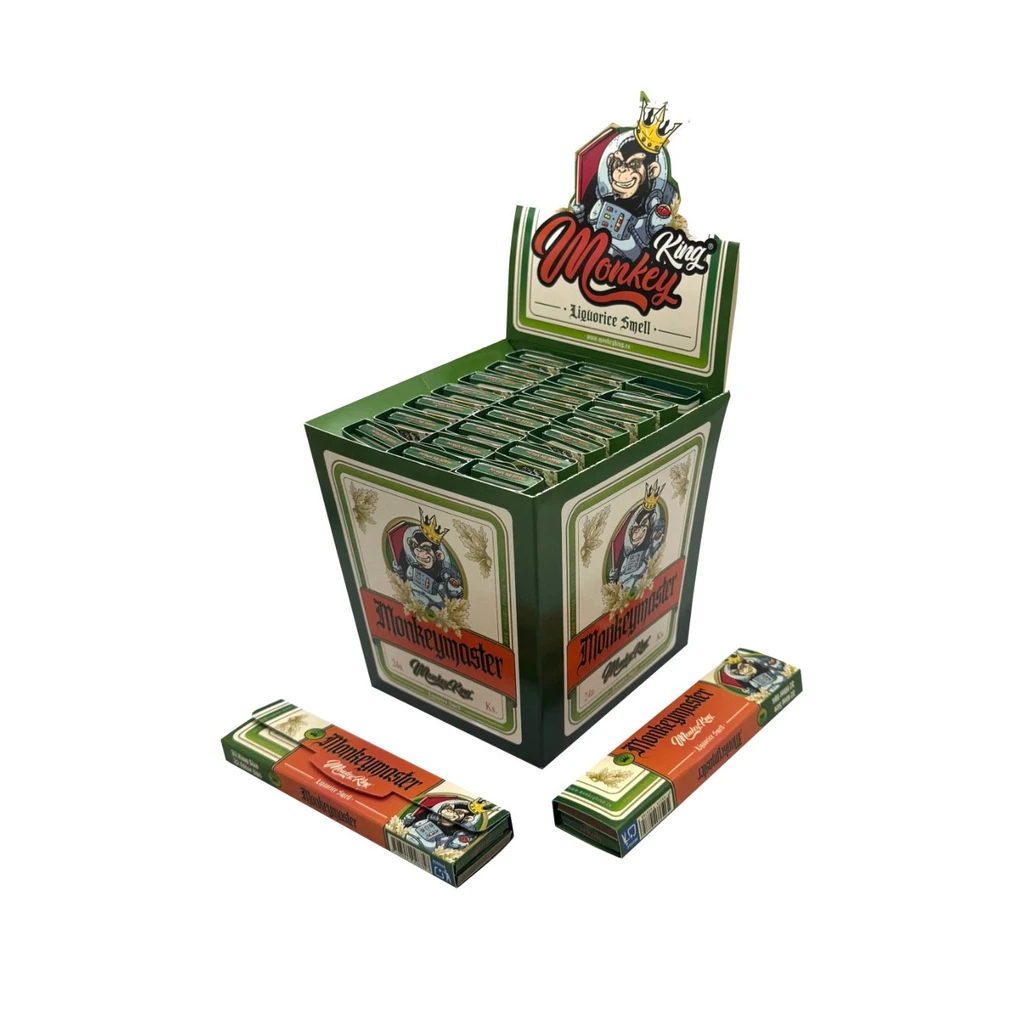Expositor verde de papel Monkey King Liquorice con libritos alineados y dos unidades delante, decorado con un mono coronado.