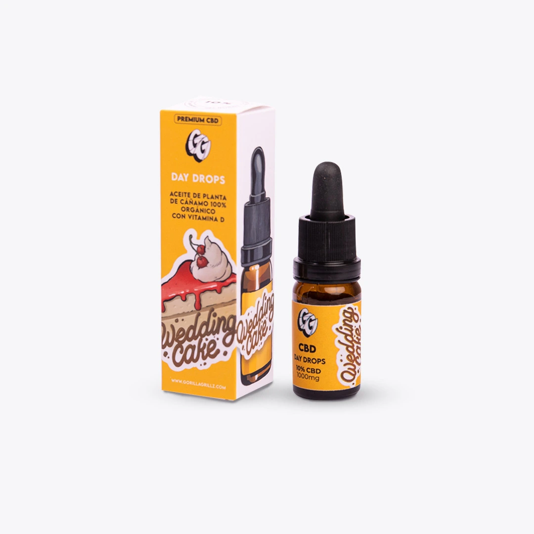 Frasco ámbar de Day Drops 10% CBD con cuentagotas negro junto a su caja amarilla y blanca con el texto Wedding Cake.