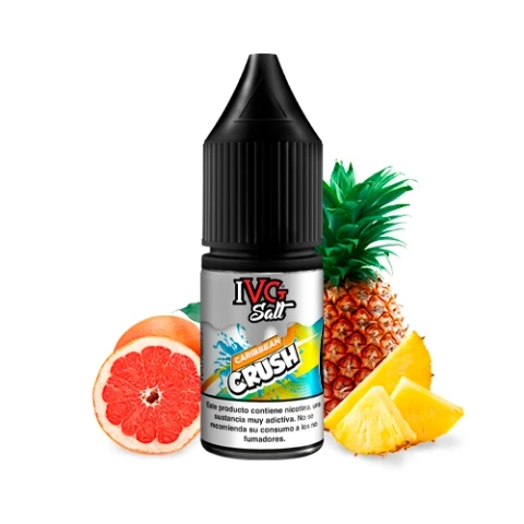 Frasco IVG Salt Caribbean Crush con tapón negro, rodeado de un pomelo cortado, una piña y varios trozos de piña sobre fondo blanco.