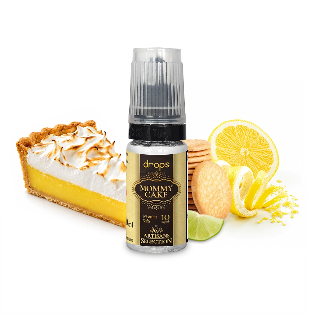 Frasco Drops Mommy Cake con tapón translúcido y etiqueta negra y dorada, junto a una tarta de merengue, galletas y cítricos.