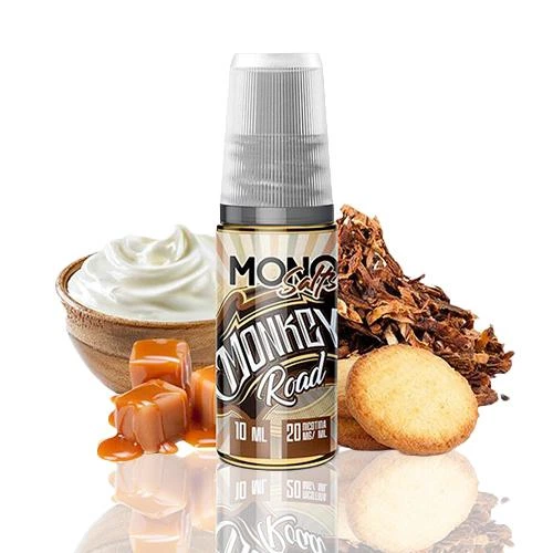 Frasco de Mono eJuice Salts Monkey Road con tapón gris, rodeado de caramelos, crema blanca, galletas y hojas marrones.
