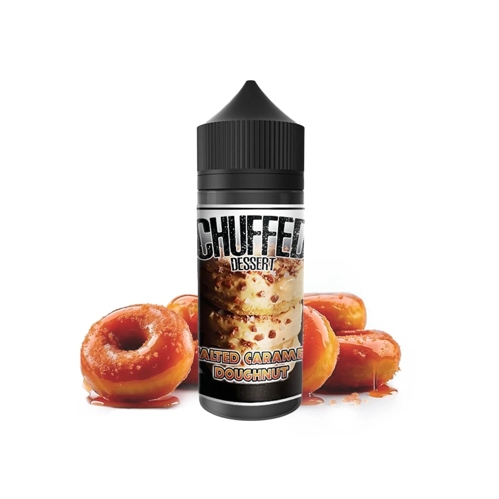 Botella Chuffed Dessert Salted Caramel Doughnut Longfill con tapón negro, delante de varios dónuts cubiertos de caramelo.